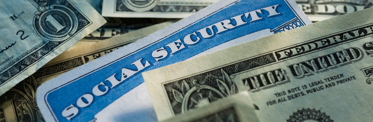 Social Security card among dollar bills